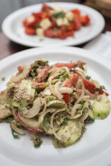 Salad of vegetables bell pepper zucchini onion is on a plate isolated