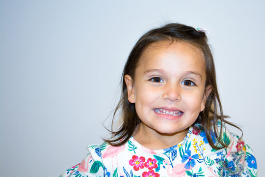 Portrait of a five year old girl making funny faces