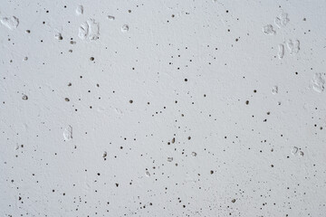 Textured concrete wall painted with white paint.