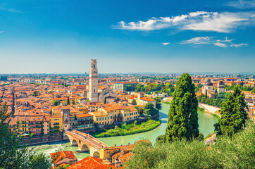 Aerial view of Verona historical city centre, Ponte Pietra bridge across Adige river, Verona Cathedral, Duomo di Verona, red tiled roofs, Veneto Region, Italy. Verona cityscape, panoramic view.