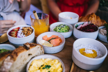 Close up view of buddha bowl with ripe vitamin fresh fruits for eating healthy fiber nutrition, cropped image of tasty food - chia yogurt with mango and salmon meat for tasting energetic breakfast
