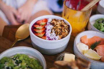 Selective focus on organic homemade sweet dessert with fresh strawberry on cafe table, copped female visitor ordered delicious nutrition food for tasting during vegetarian lunch keep healthy lifestyle