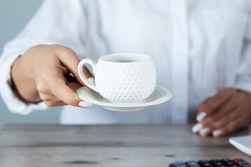 woman hand cup of coffee with document