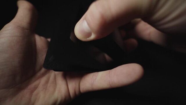 Man showing trick with playing cards. (Hands only). Slow motion footage.