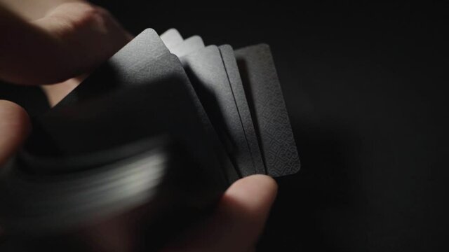 Man showing trick with playing cards. (Hands only). Slow motion footage.