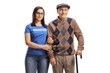 Woman volunteer standing with a senior male pensioner with a walking cane