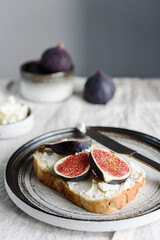 Sandwich with Ricotta and fresh Figs on natural linen tablecloth. Simple healthy breakfast