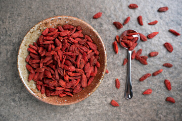 Goji berries in a bowl on table. Top view goji berries with copy space.
