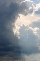 Naklejka na ściany i meble The sun's rays break through the storm clouds.