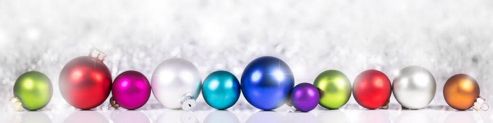 Festive Header with colorful Christmas balls in front of sparkling background