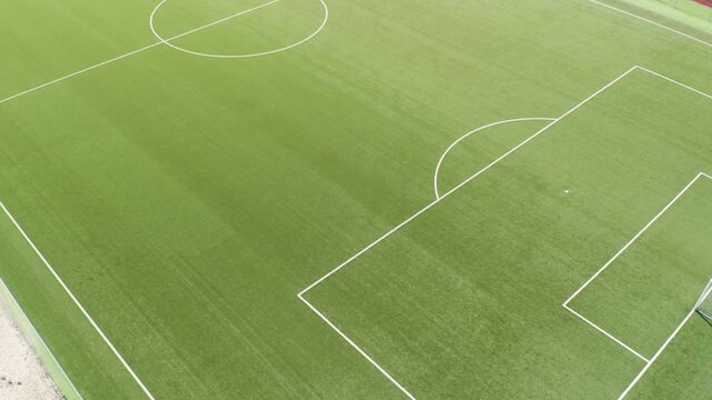 Aerial view of an empty green field in a soccer stadium