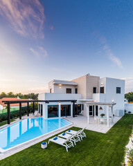 Modern house with garden swimming pool and wooden pergula