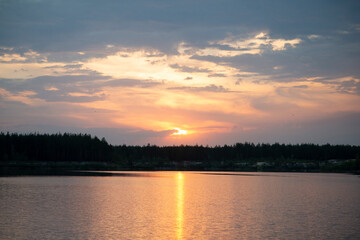 Sunset over a forest lake. Beautiful view.