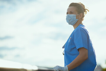 medical practitioner woman outside in city against sky