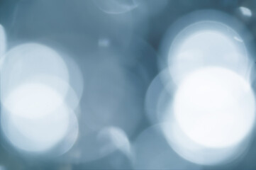 Disposessory abstract Christmas background in blue. Abstract bokeh on a blue background of circles of various sizes.