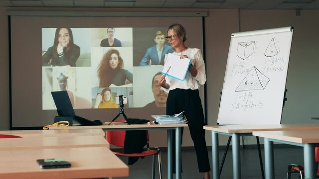 Online learning, online education, distance learning, distance education concept. Female teacher is having a multiuser online lesson for adults