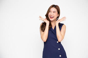 Portrait of excited screaming young asian woman standing in blue dress isolated over white background, Wow and surprised concept