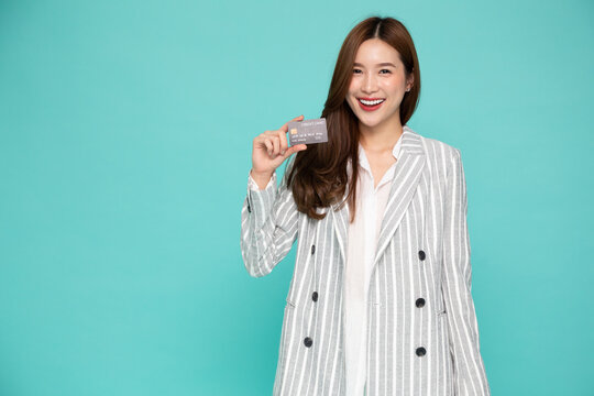 Young Beautiful Asian Woman Smiling, Showing, Presenting Credit Card For Making Payment Or Paying Online Business, Pay A Merchant Or As A Cash Advance For Goods, Cardholder Or A Person Who Owns A Card