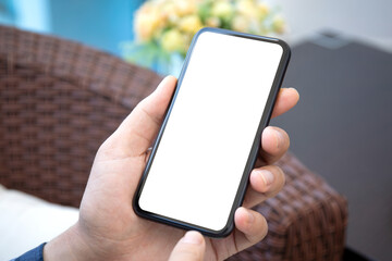 male hand holding phone with isolated screen in room house