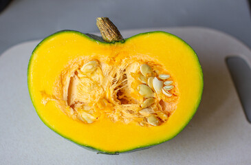 Cut the green pumpkin in the fall. Yellow pumpkin with seeds