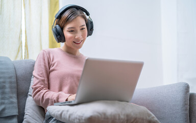 Asian business woman working at home, She talks to her co-workers using video conferencing.