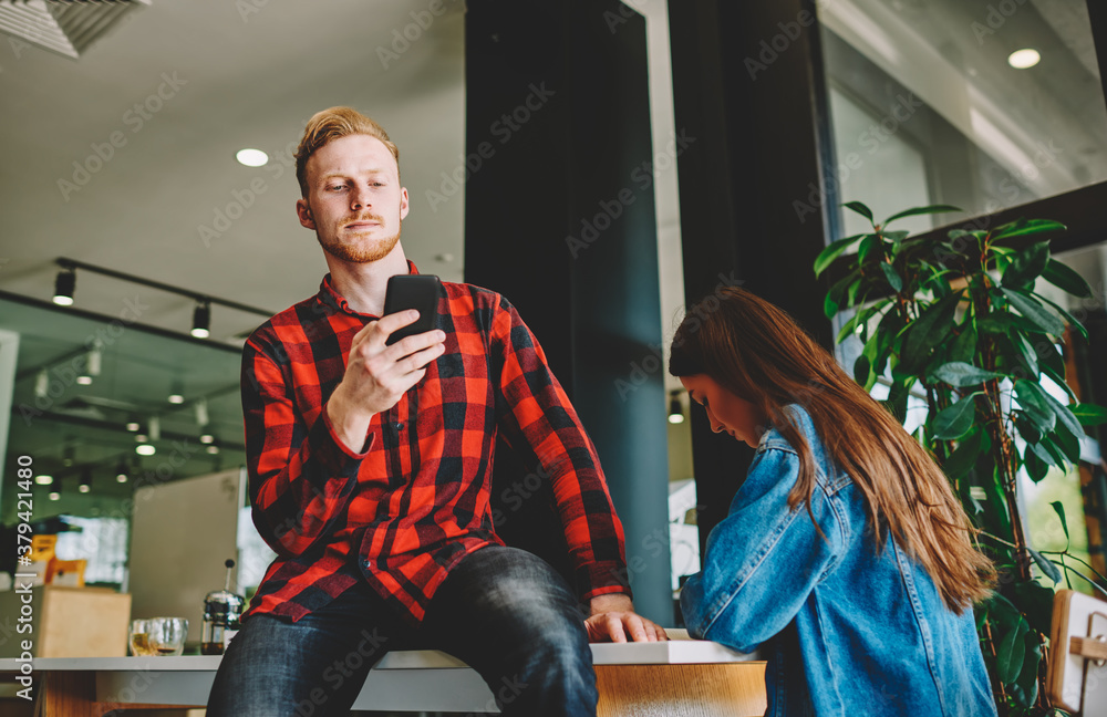 Aufkleber caucasian hipster guy installing smartphone application for reading email newsletter subscription, m