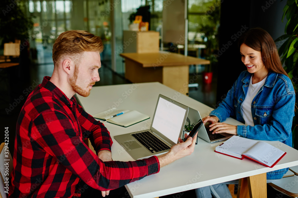 Aufkleber caucasian male programmer sitting at table desk with happy female colleague checking received email 