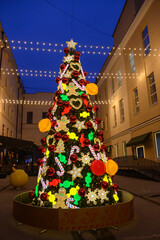 Creative outdoor christmas tree and glowing garlands
