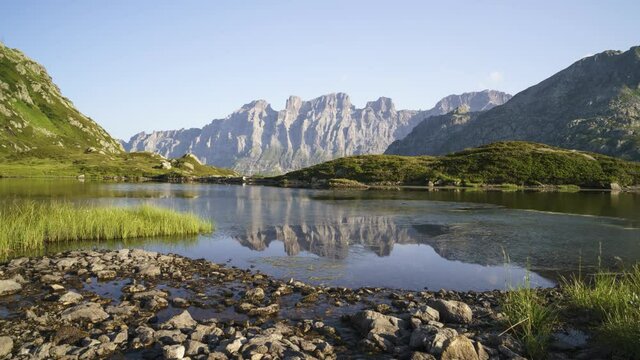 Rocky Mountain Of Titlis From The Seebodensee Lake Close To The Susten Pass And Stein Glacier On A Sunny Summer Day In Switzerland. - timelapse