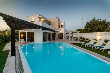 Modern house with garden swimming pool and wooden pergula