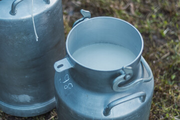 man puring milk on a millk jar