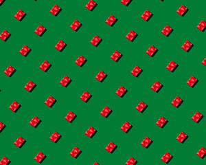 red gift on green background pattern