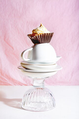 Vanilla cupcake with whipper cream on pink background. Teatime concept