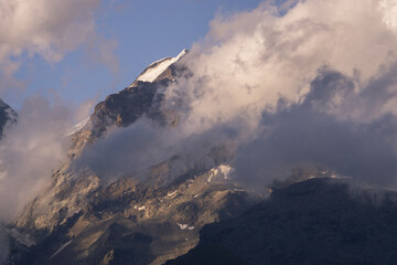 View of Castore Peak (Monterosa) from the village of Lignod, Ayas valley in italy (Aosta), sorrounded by clouds  during the sunset.