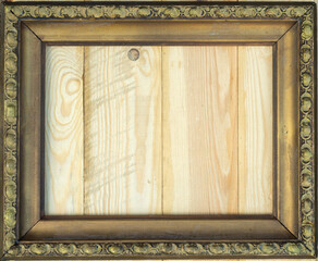 Antique gold frame with wooden background, space for inscription