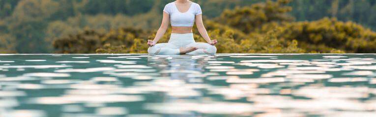 Banner Calm of Beautiful Attractive .. woman practice yoga Lotus pose on the pool above the Mountain peak in the morning in front of beautiful nature views,Feel so comfortable and relax in holiday