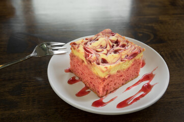 Fresh raspberries cheese cake on white plate.