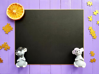 blackboard with mice. Orange slices, puzzles and mice on a purple background. In the center there is a place for the inscription