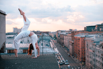 girl doing gymnastics exercise on the roof