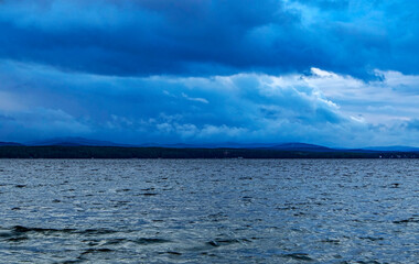 dark overcast sky over the lake on a summer evening, gloomy clouds