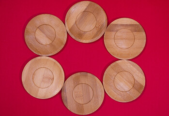 Bamboo saucers arranged in various order, with space to insert letters of text
