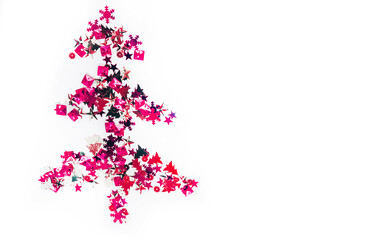 Shiny Christmas tree isolate. Figure of a Christmas tree on a white background of shiny multi-colored confetti. Happy new year and merry Christmas.