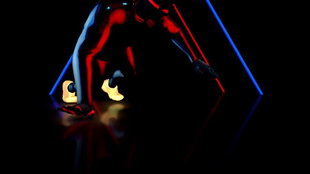 Low angle view of male dancer performs in futuristic metallic neon costumes, 3D Rendering Animation.
