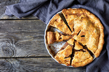 Apple pie cut in slices top view, copy space