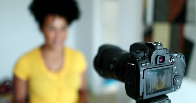 Mixed race woman giving testimony in front of camera vlogging
