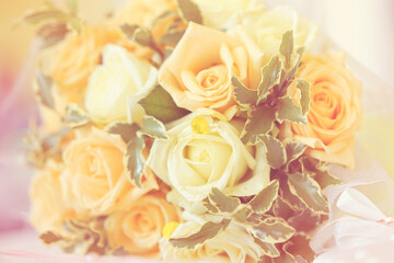 beautiful wedding bouquet from yellow and red rose flowers lying on decorative table