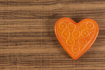 Orange heart on background with space for writing