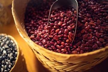 Exotic colorful mexican beans on wicker basket. Top view of legumes. Concept of beans food. Exotic beans on wooden table. Rustic background of beans. Colorful legumes on rustic setting