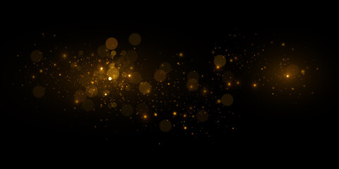 Naklejka na ściany i meble Transparent golden light effect. Magical sparkles isolated on black background.