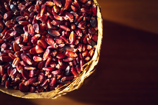 Red mexican corn on wicker basket. Top view of red corn. Concept of corn food